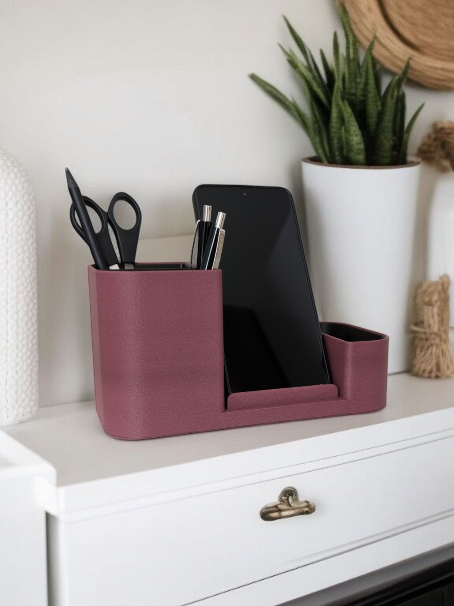 Minimalist desk organizer styled on home office desk with pen and phone