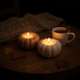 Pumpkin tealight holder in cream, close-up showing smooth surface