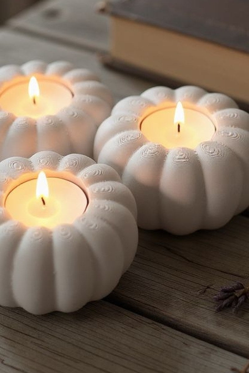 Close-up of ribbed pumpkin tealight holder showing texture and three candle recesses