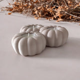 Close-up of ribbed pumpkin tealight holder showing texture and three candle recesses