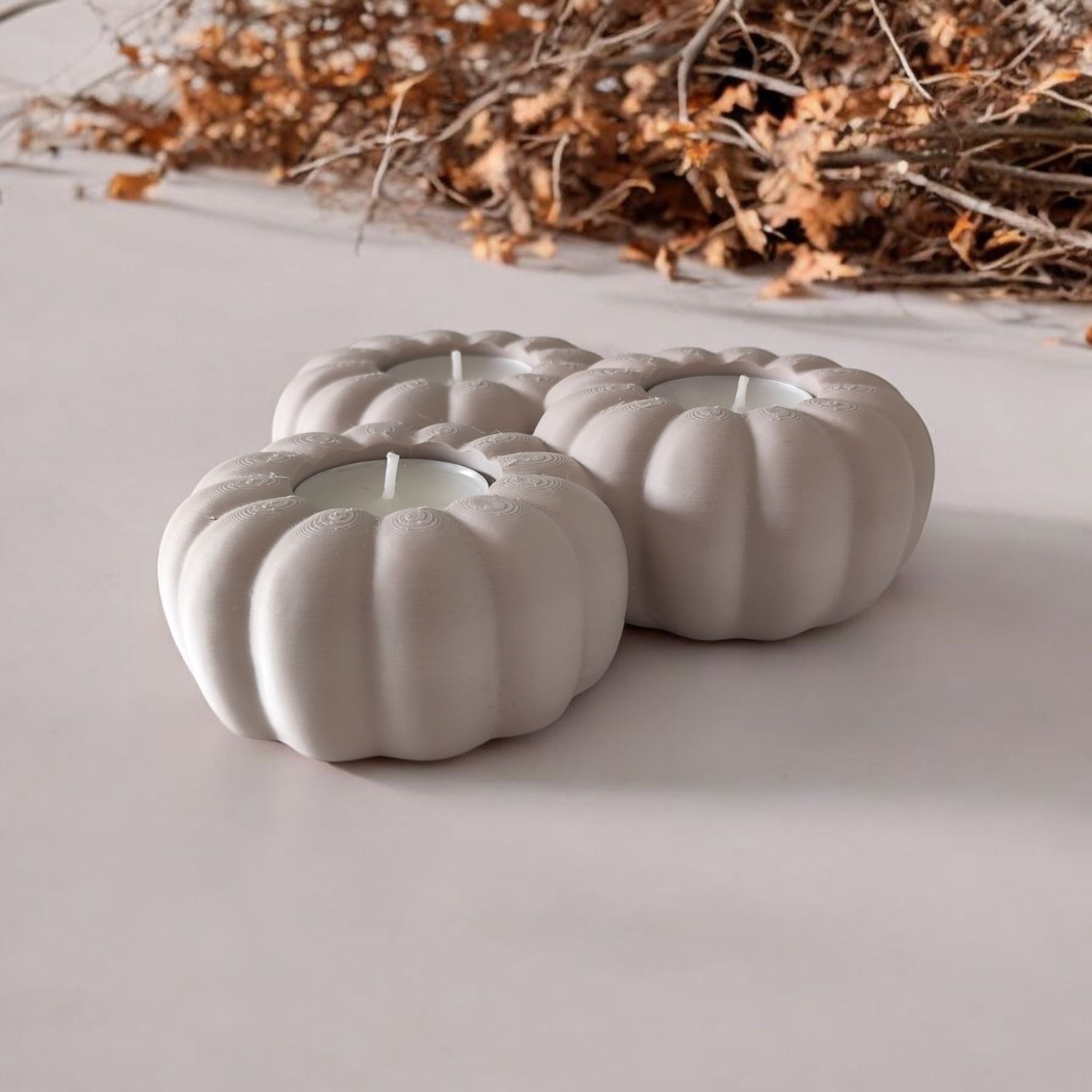 Close-up of ribbed pumpkin tealight holder showing texture and three candle recesses