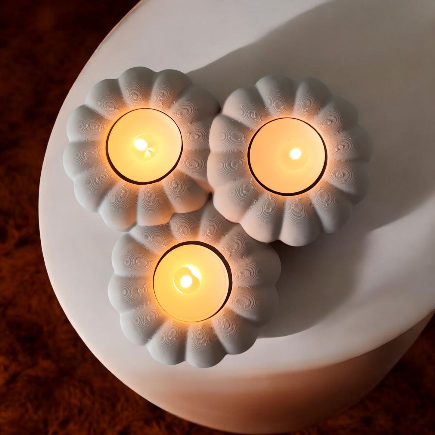 Close-up of ribbed pumpkin tealight holder showing texture and three candle recesses