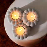 Close-up of ribbed pumpkin tealight holder showing texture and three candle recesses