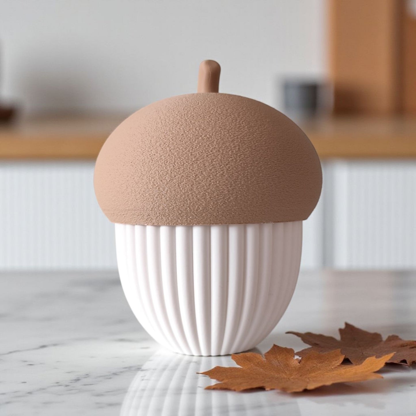 Ribbed acorn container styled on a shelf with autumn decor and warm lighting