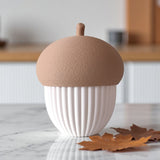 Ribbed acorn container styled on a shelf with autumn decor and warm lighting