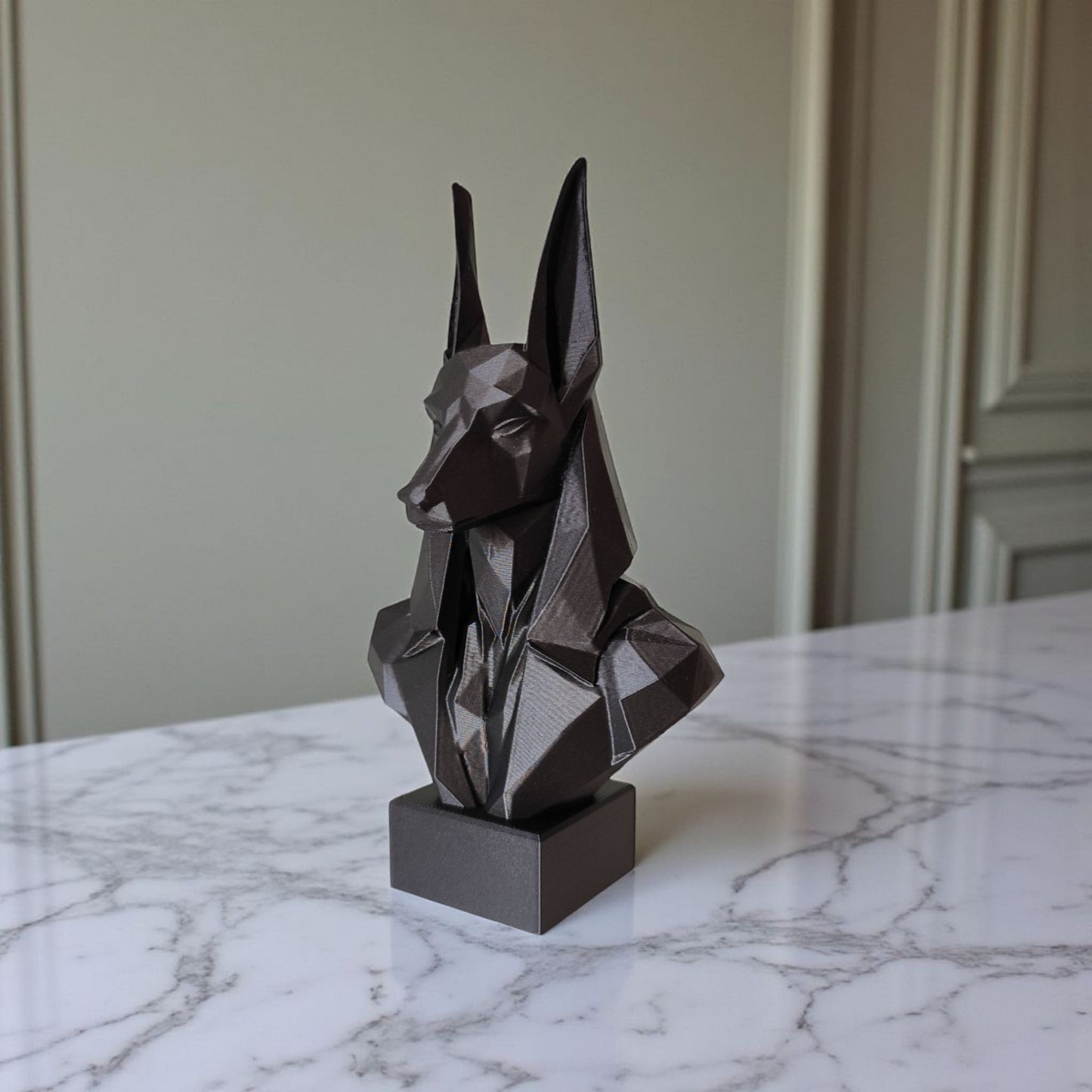 Close-up of low poly anubis bust showing faceted geometric surfaces