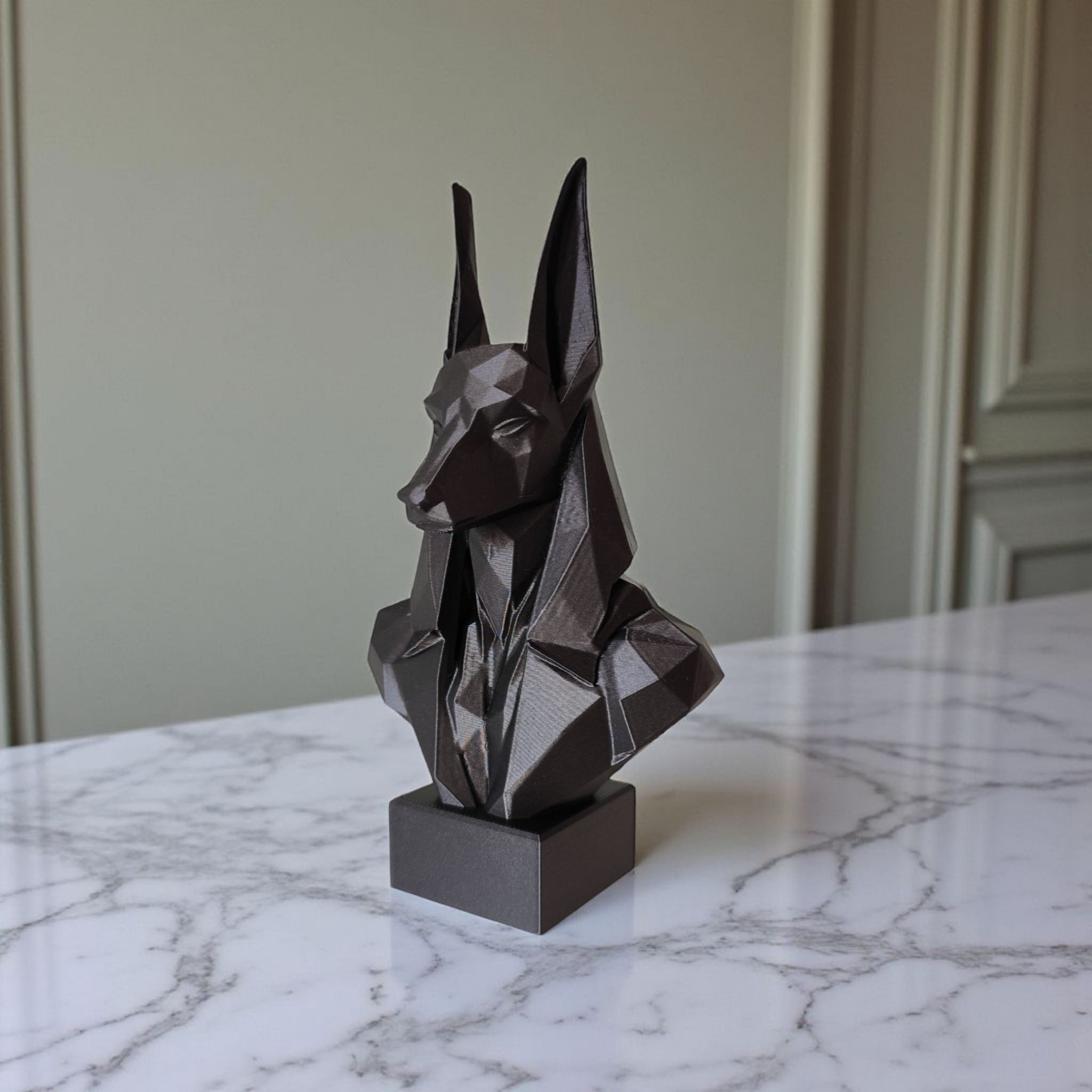 Close-up of low poly anubis bust showing faceted geometric surfaces
