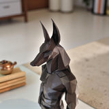Low poly anubis statue displayed on a light shelf with minimal decor styling