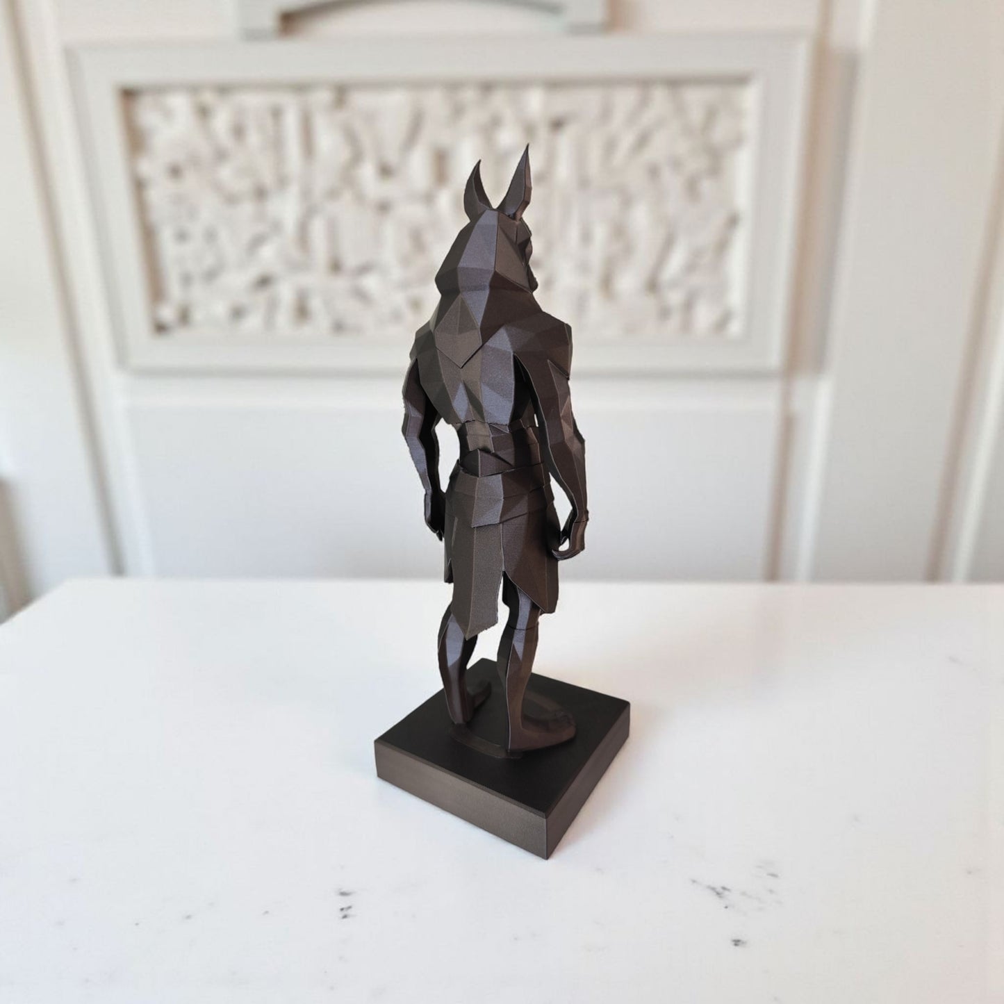 Close-up of low poly anubis statue showing geometric faceted surfaces and angular design