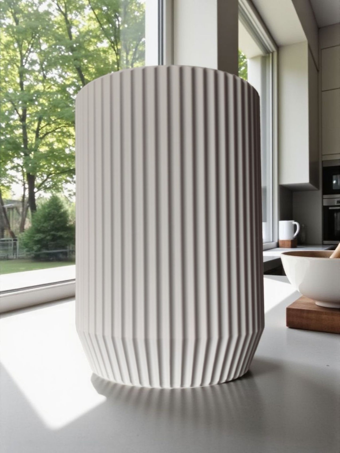Ribbed texture pattern on cream-colored utensil holder catching soft light