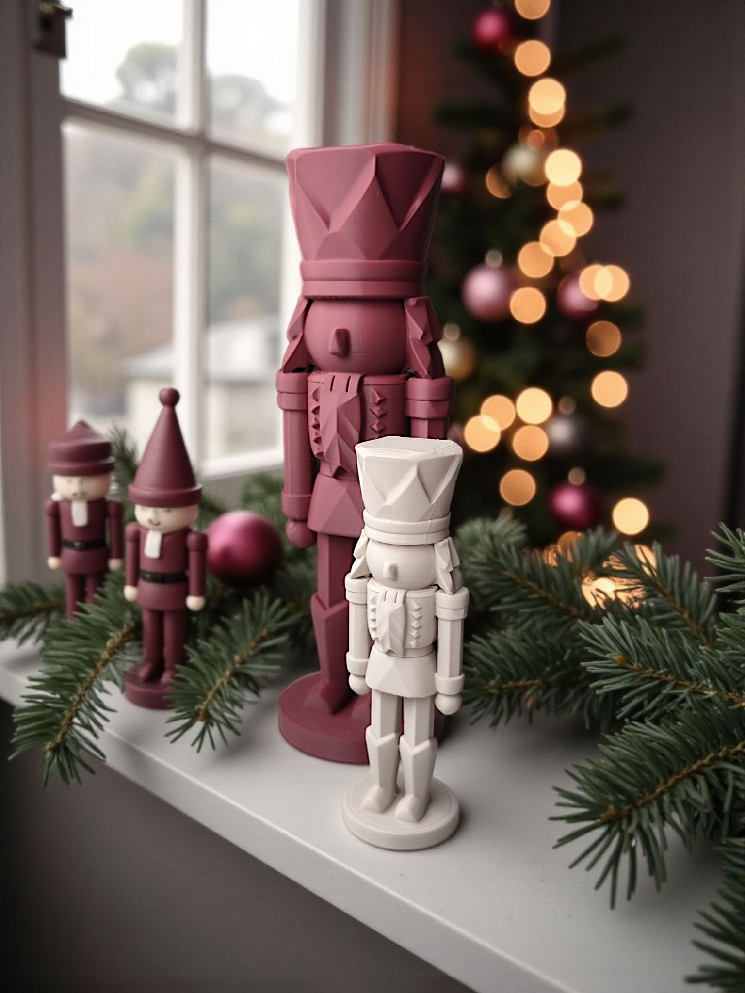 Modern nutcracker displayed on a windowsill with holiday greenery