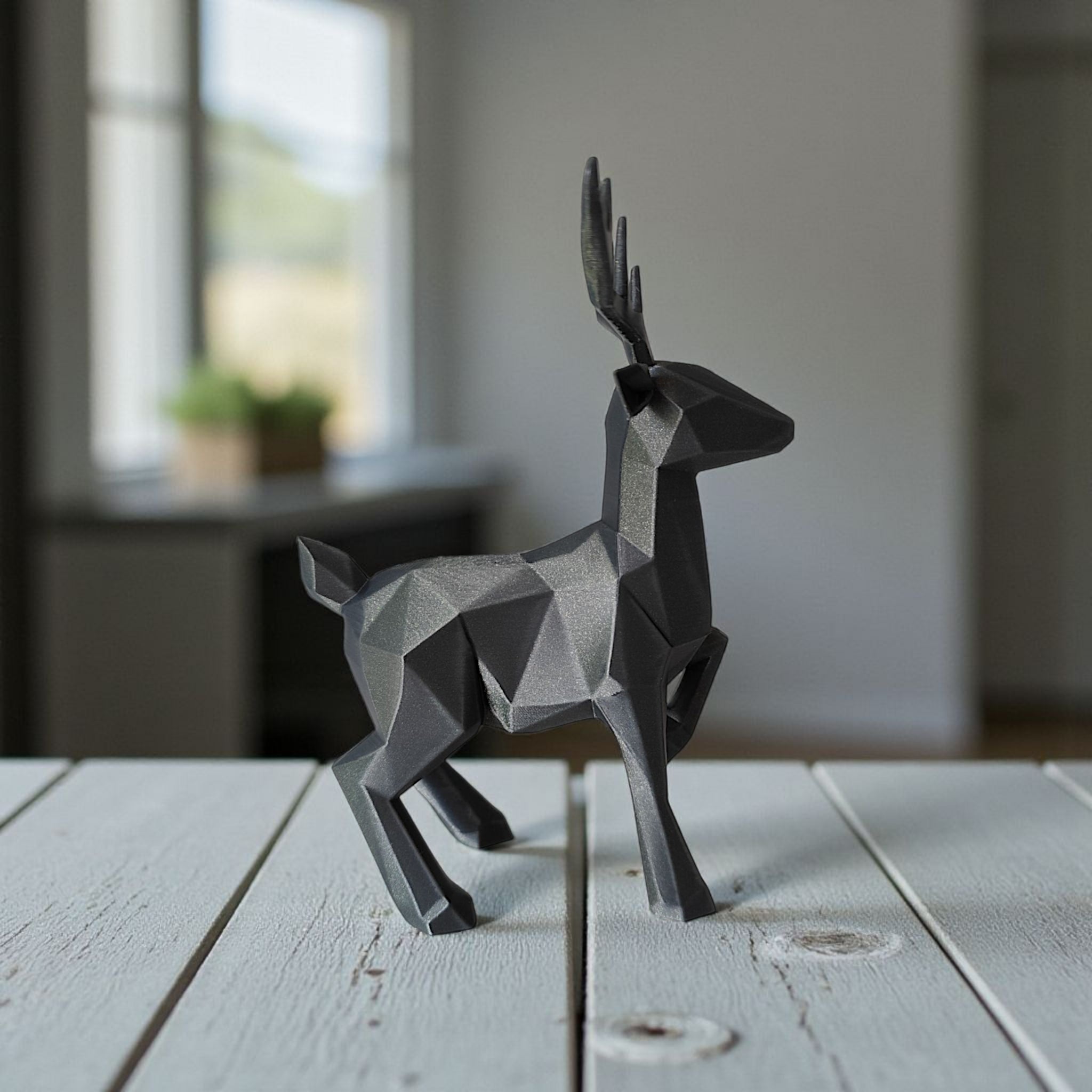 Minimalist low poly reindeer displayed on white shelf in bright interior