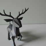 Close-up of minimalist low poly reindeer showing geometric faceted surface and antlers