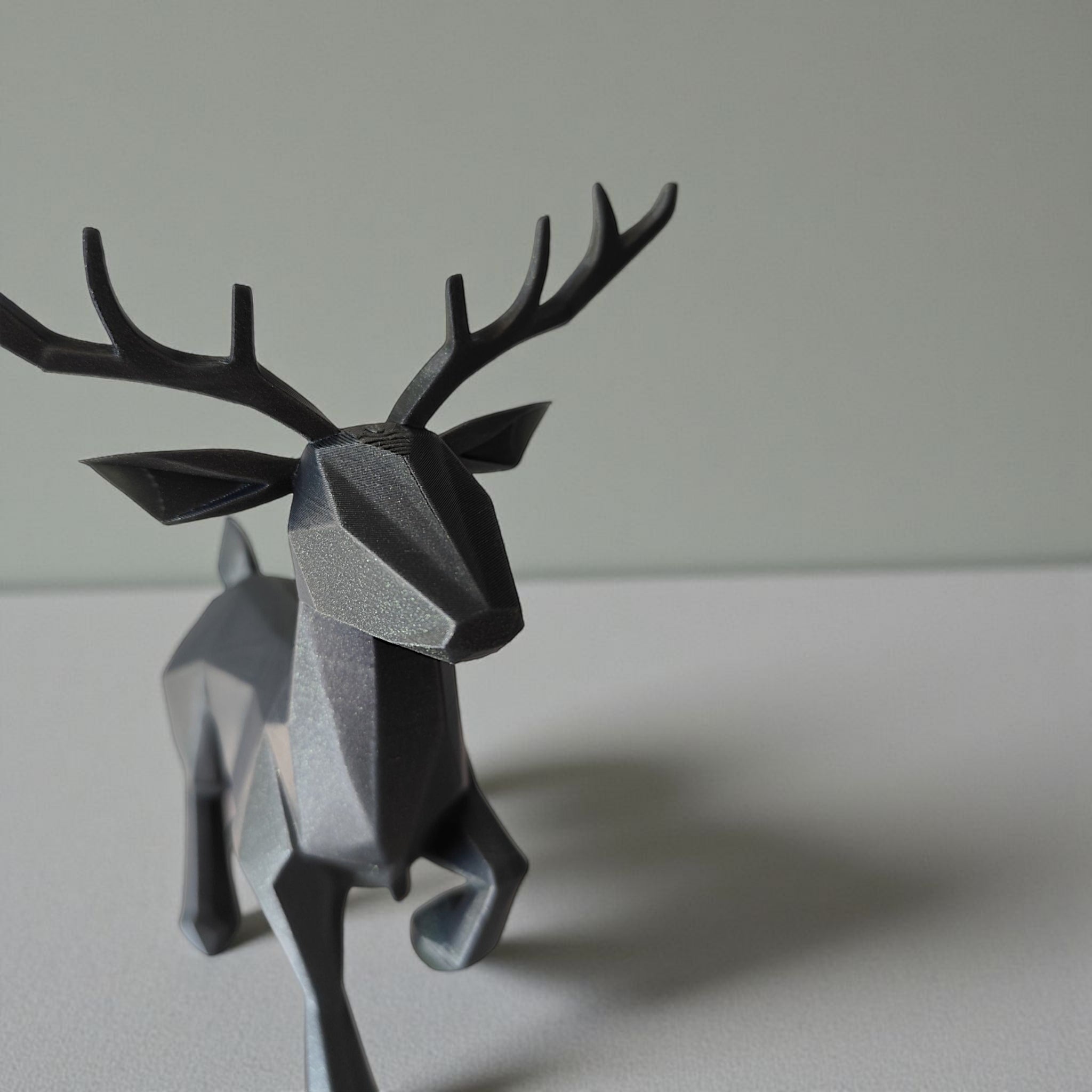 Close-up of minimalist low poly reindeer showing geometric faceted surface and antlers