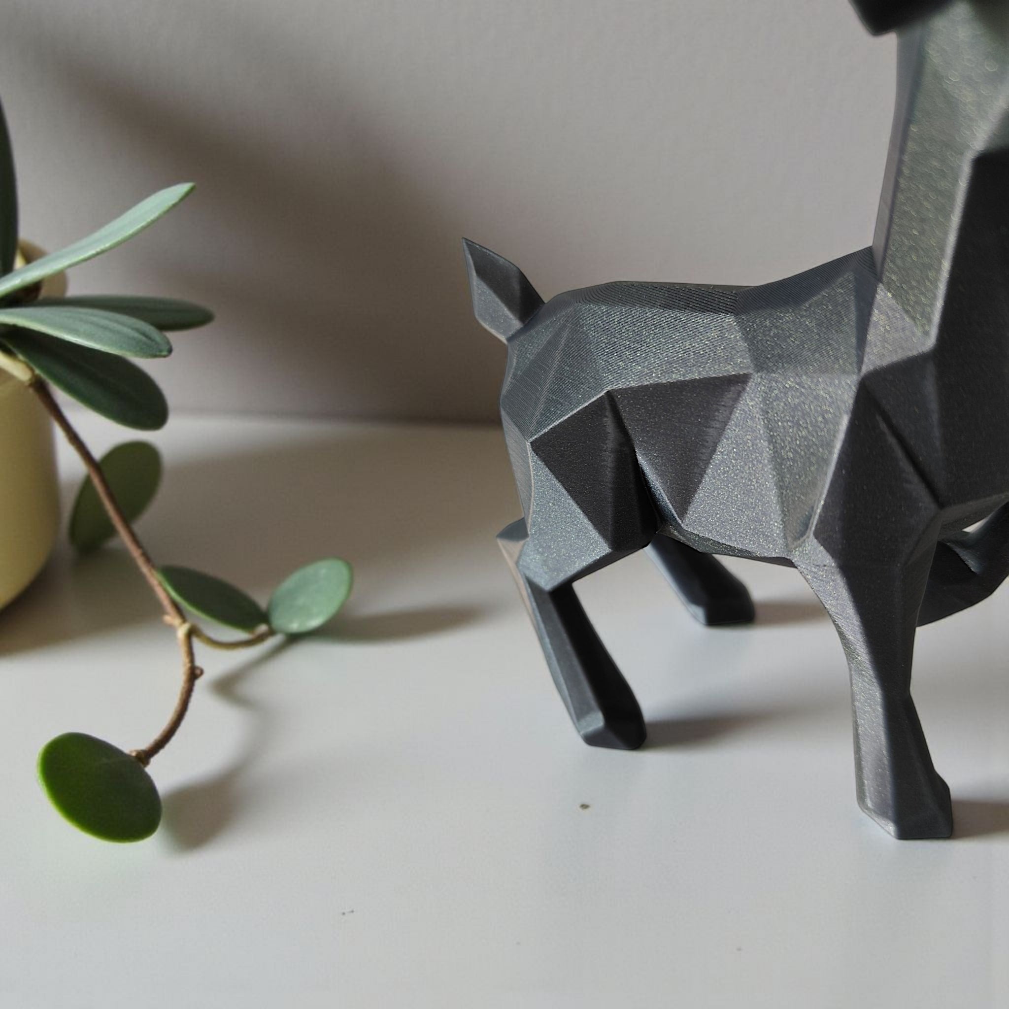 Close-up of minimalist low poly reindeer showing geometric faceted surface and antlers