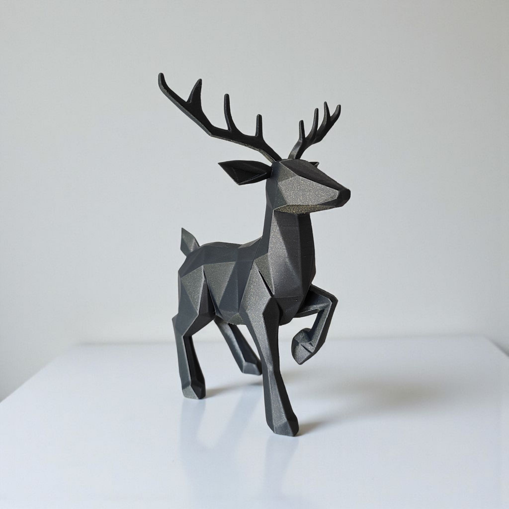 Close-up of minimalist low poly reindeer showing geometric faceted surface and antlers