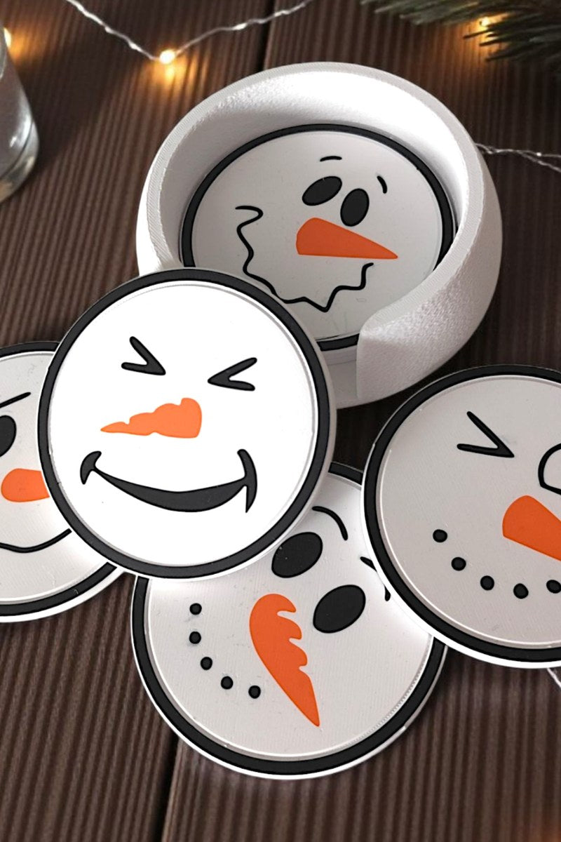 Six snowman coasters with different faces stacked in matching holder