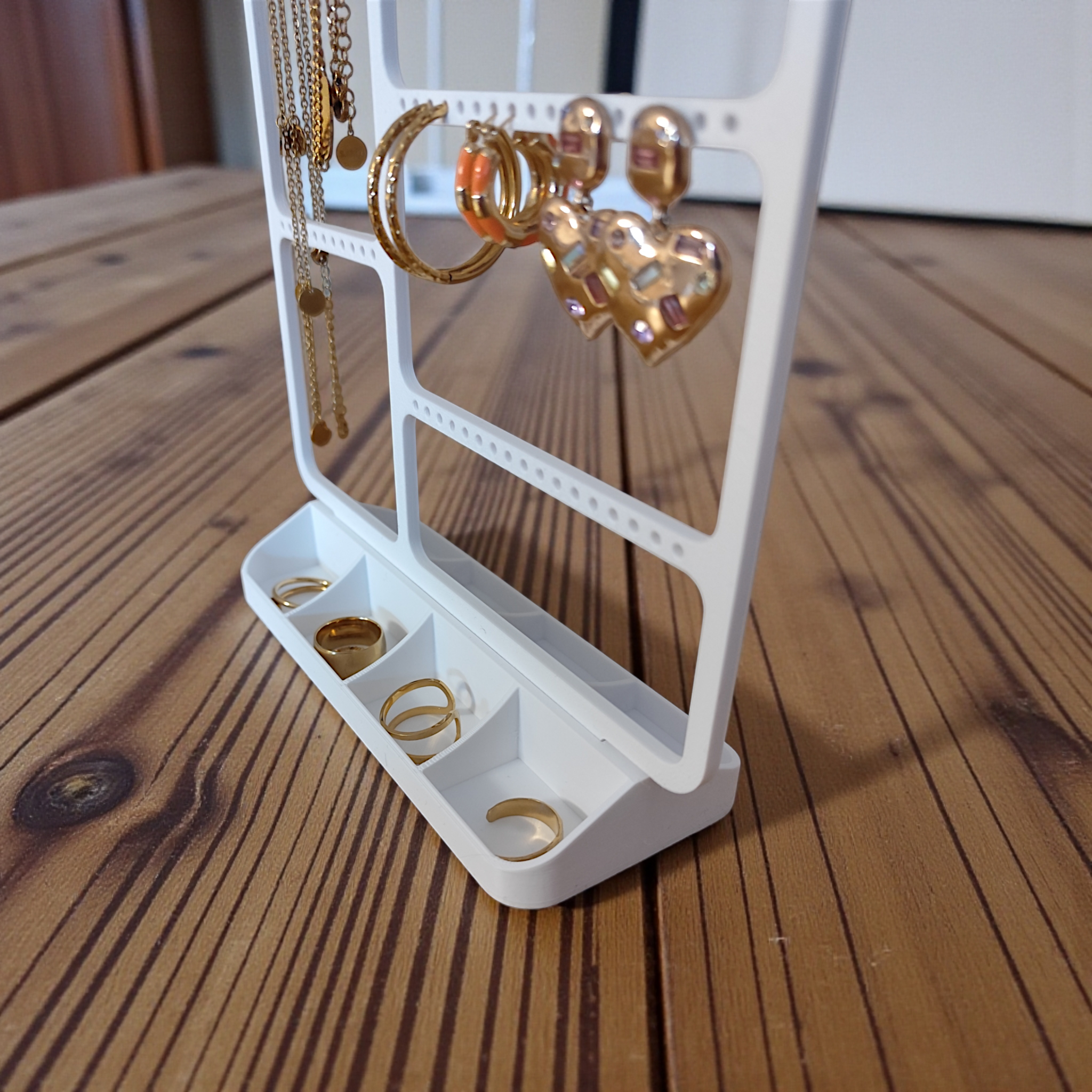 Close-up of minimalist jewelry organizer showing detailed structure for storing rings and earrings