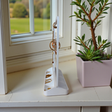 Minimalist jewelry organizer displaying earrings, rings, and necklaces in clean white design