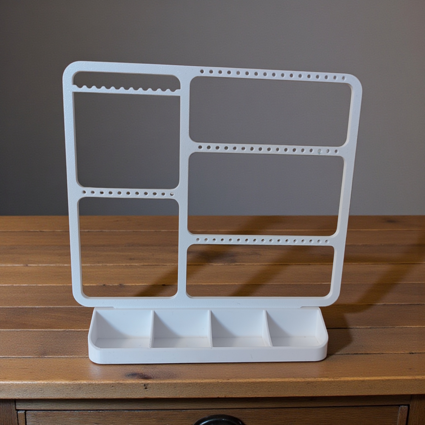 Minimalist jewelry organizer displaying earrings, rings, and necklaces in clean white design