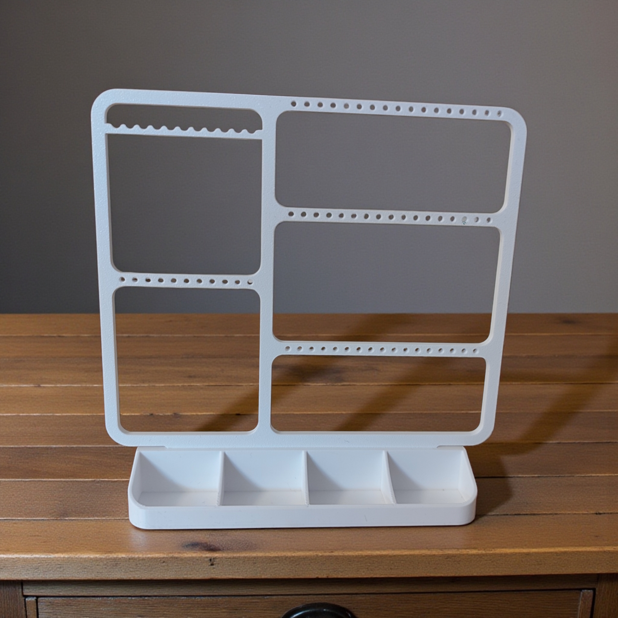 Minimalist jewelry organizer displaying earrings, rings, and necklaces in clean white design