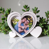 Heart-shaped picture frame with small heart base in white, close-up view