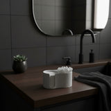 Cotton pad dispenser styled on bathroom shelf with plant and ceramics