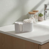 Ribbed cotton pad dispenser close-up showing textured surface detail