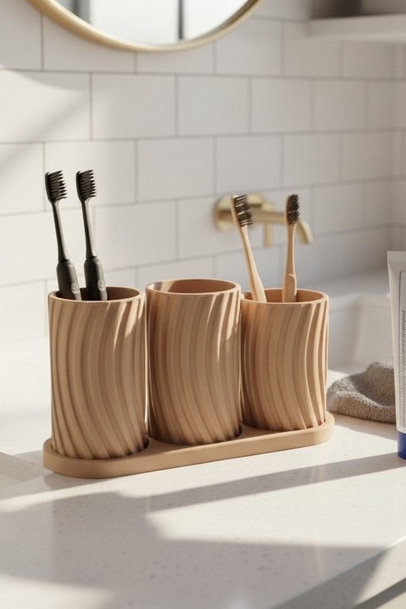 Three pale toothbrush holder cups nestled in a matching tray from the Little Family set