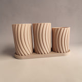 Close-up detail of the toothbrush holder set showing the soft curves and tray base
