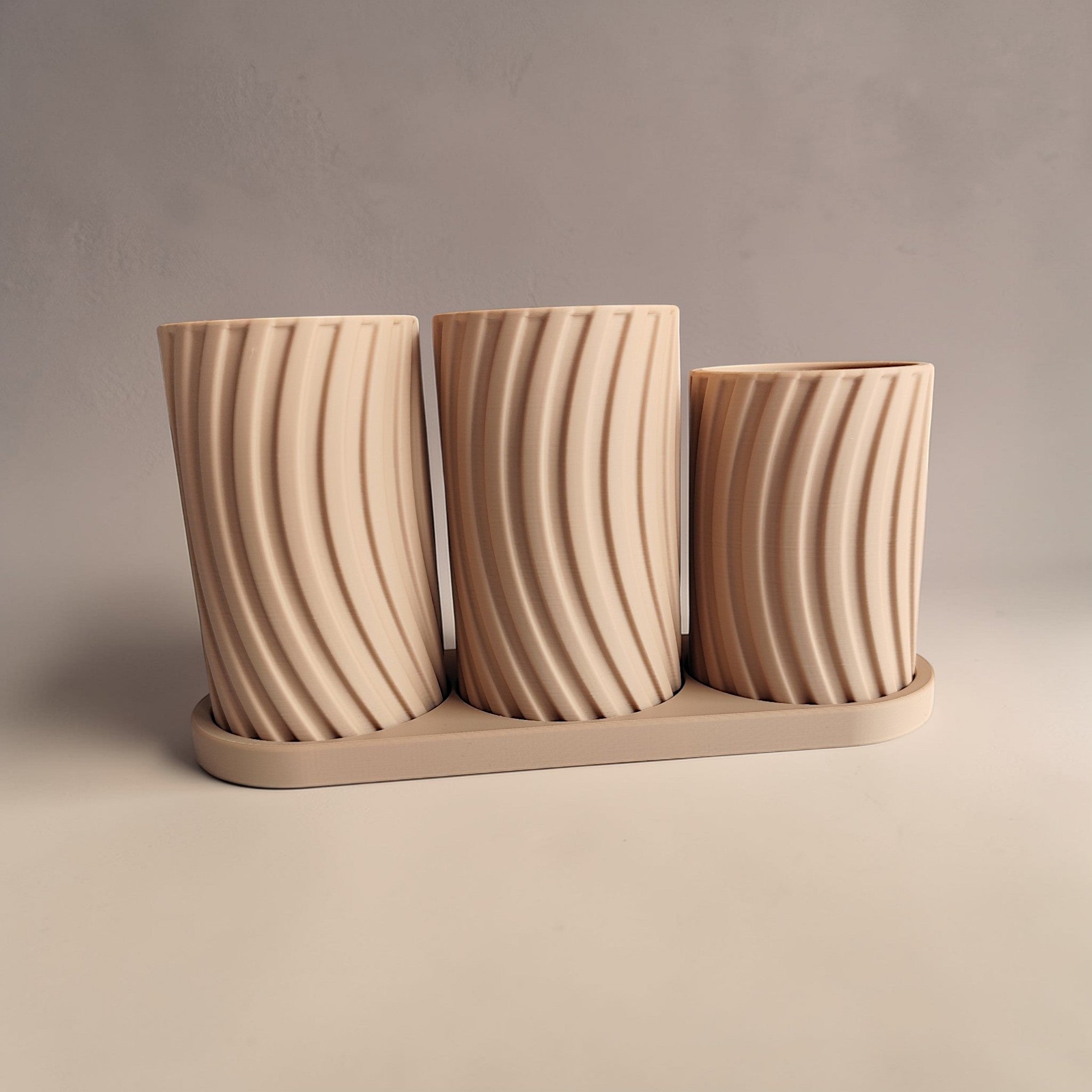 Close-up detail of the toothbrush holder set showing the soft curves and tray base