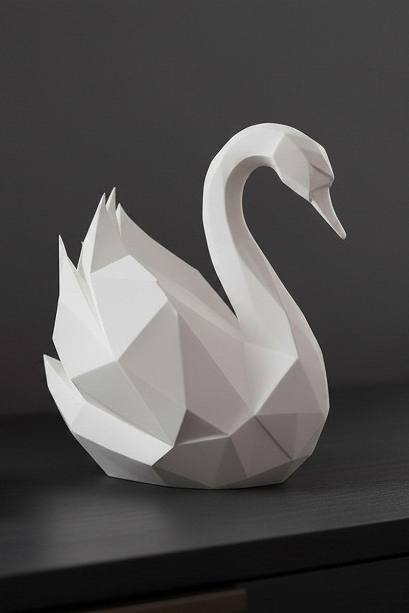 White low poly swan sculpture with angular geometric form, close-up detail