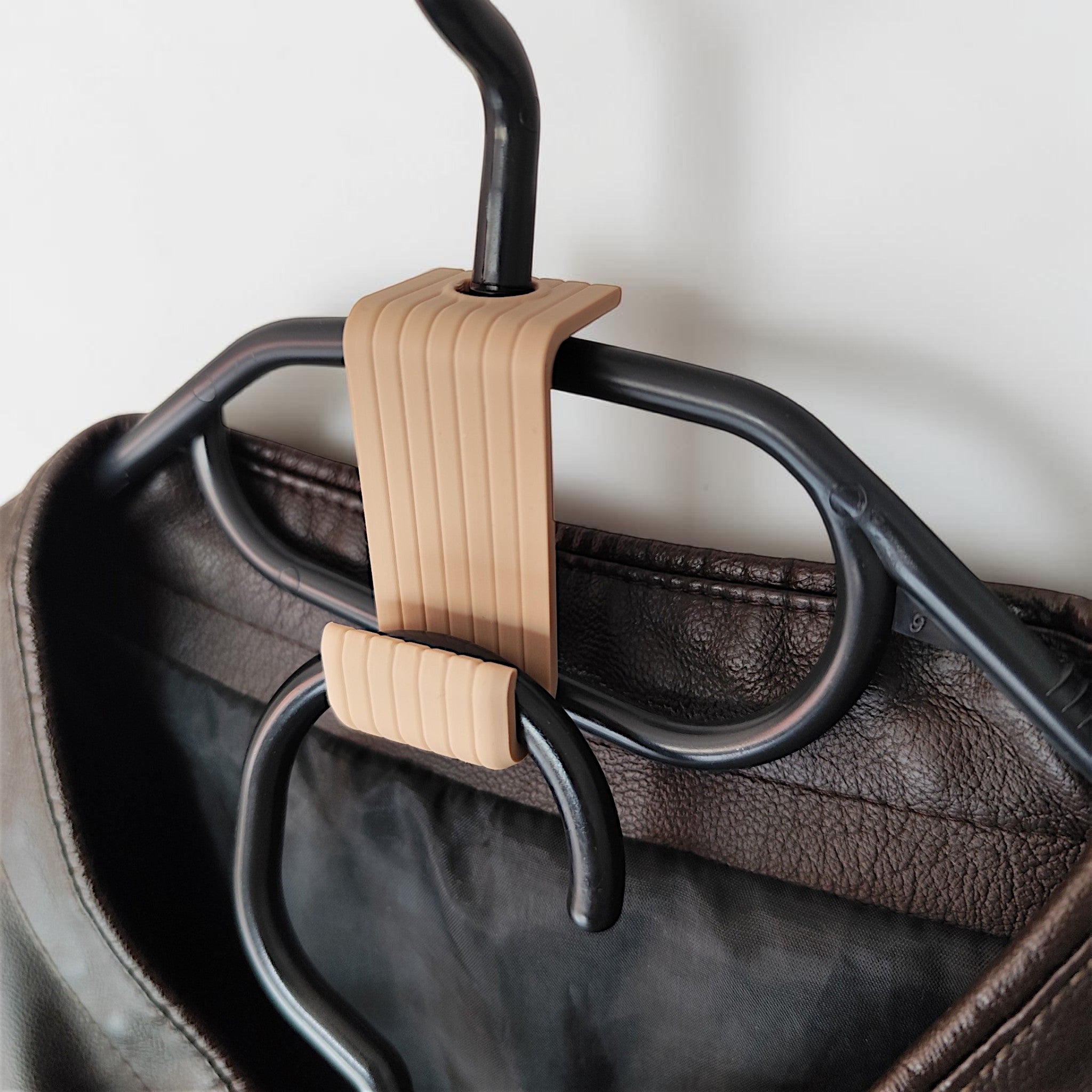 Clever clothes hanger hook connecting two wooden hangers