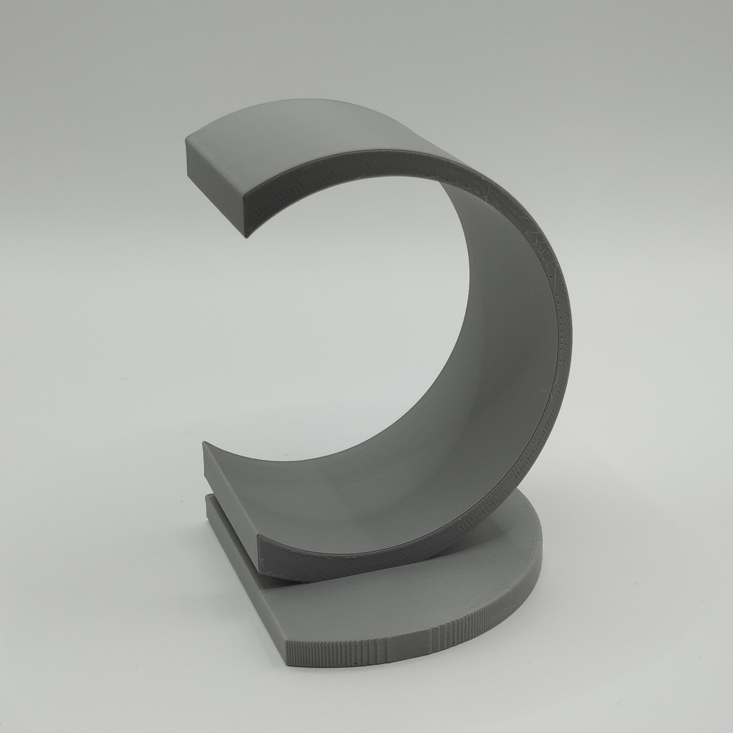 Minimalist circle bookend displayed with reading materials in home library