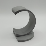 Minimalist circle bookend displayed with reading materials in home library