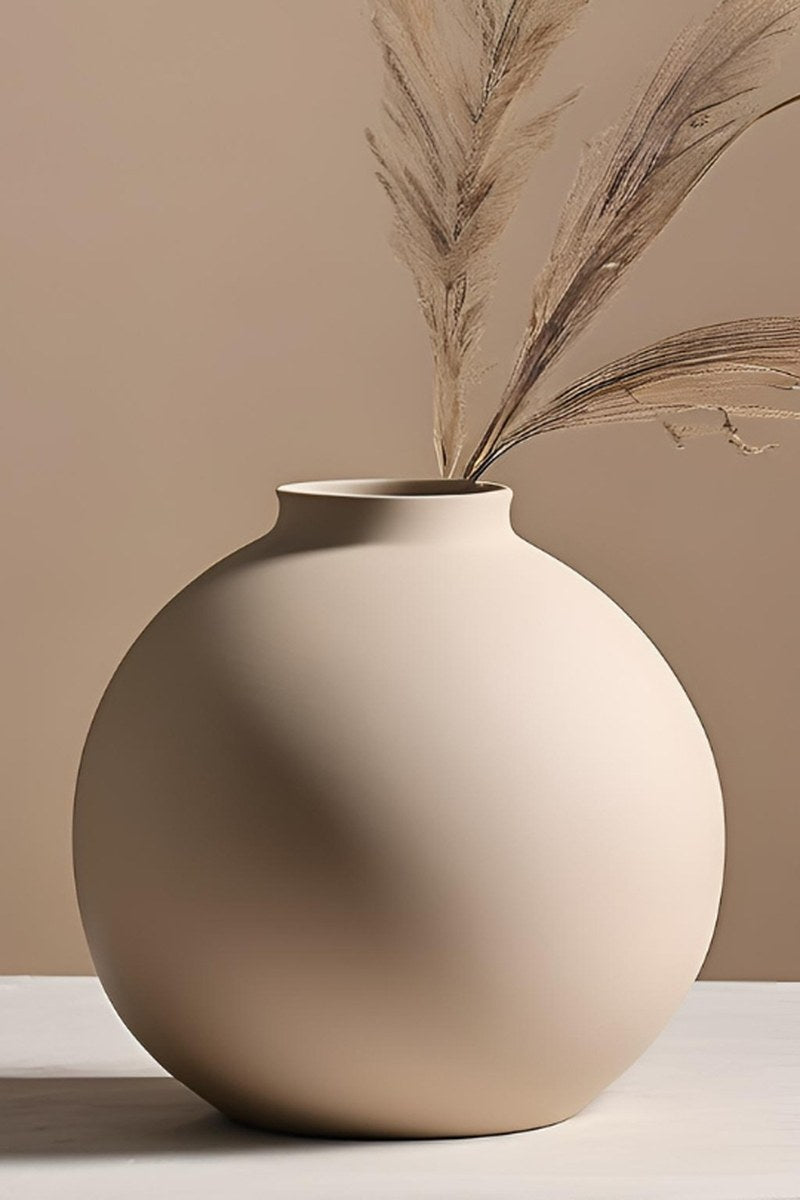 Close-up of minimalist round vase showing smooth spherical form and clean surface