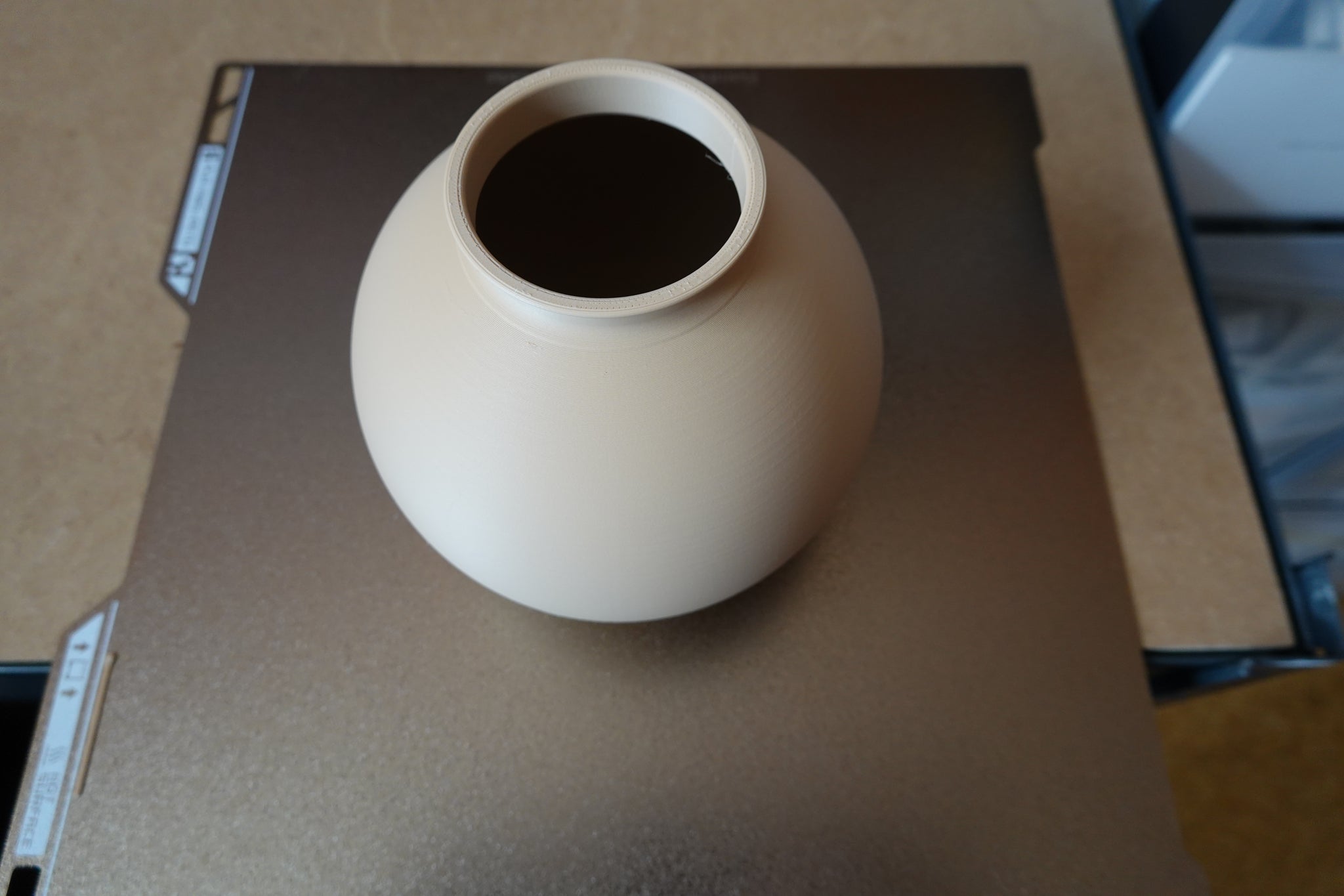 Close-up of minimalist round vase showing smooth spherical form and clean surface