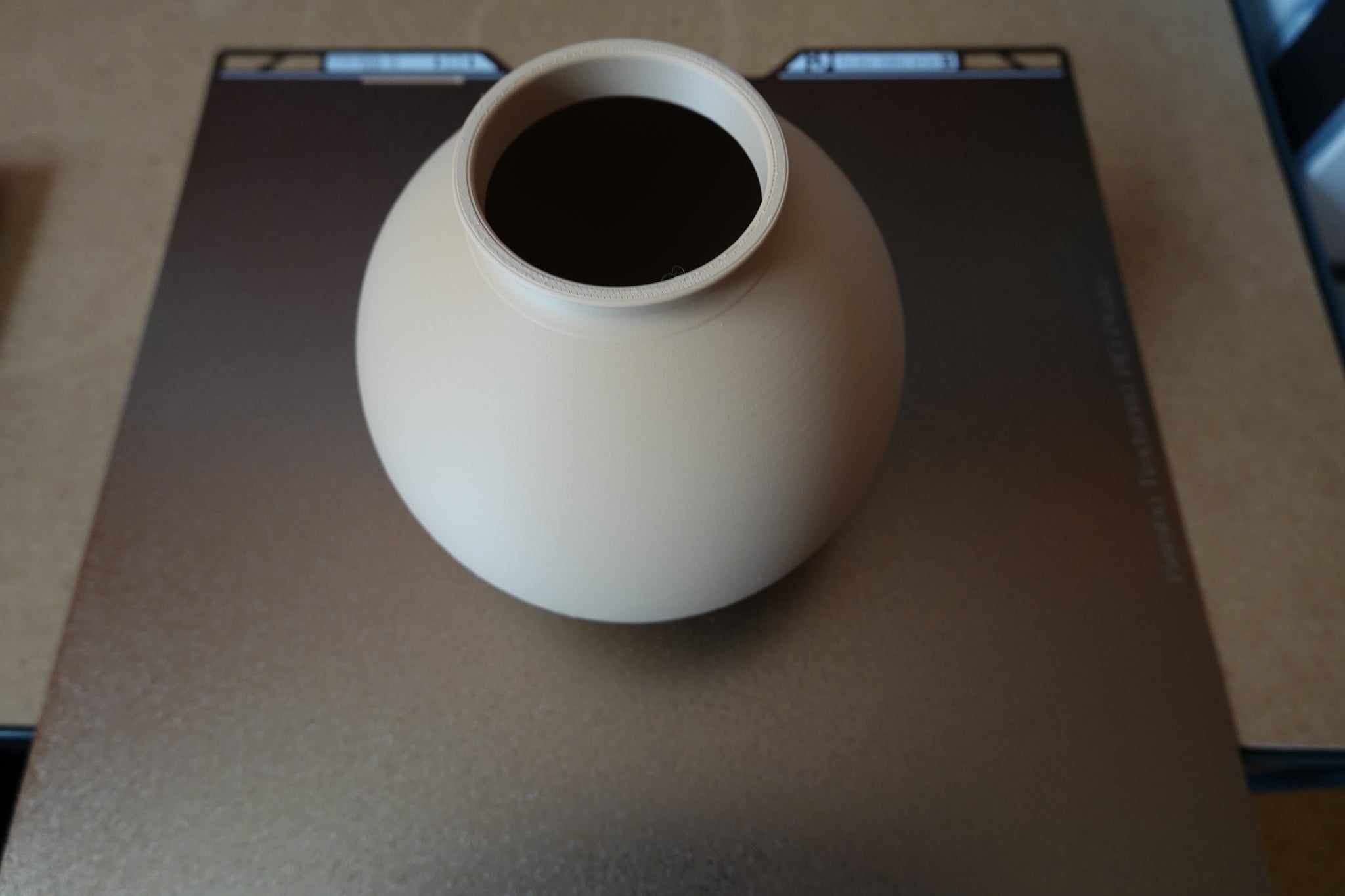 Close-up of minimalist round vase showing smooth spherical form and clean surface