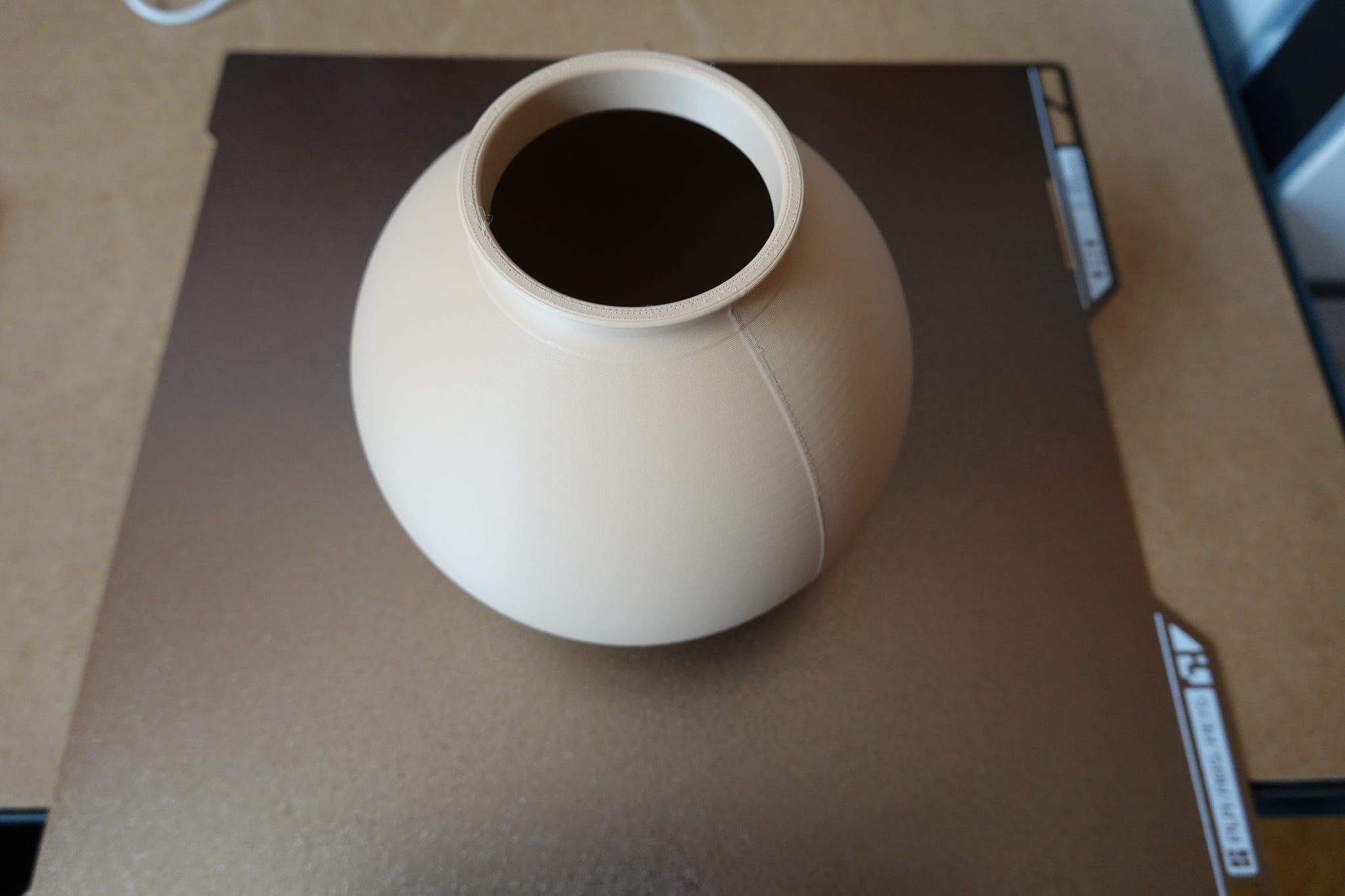Close-up of minimalist round vase showing smooth spherical form and clean surface