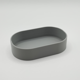 Minimalist key tray styled in modern entryway with keys resting inside, wooden shelf backdrop