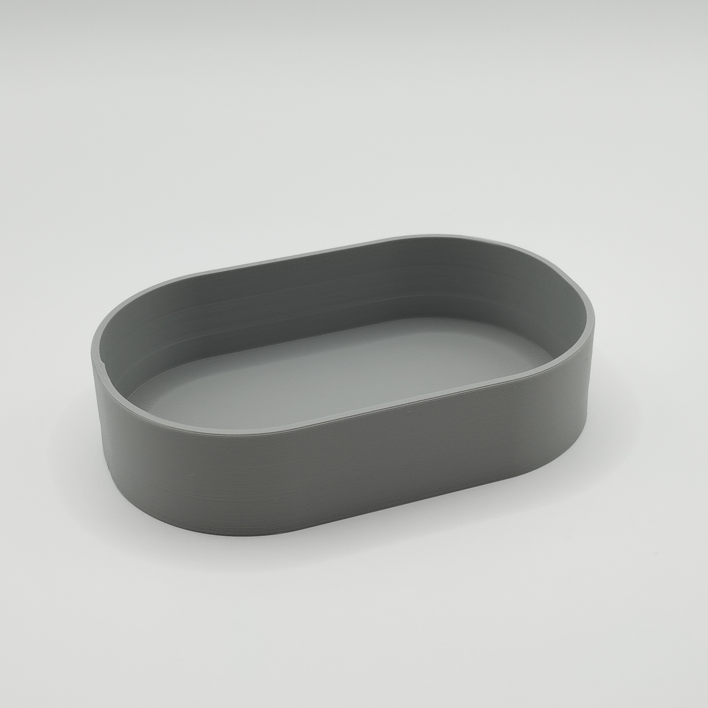 Minimalist key tray styled in modern entryway with keys resting inside, wooden shelf backdrop