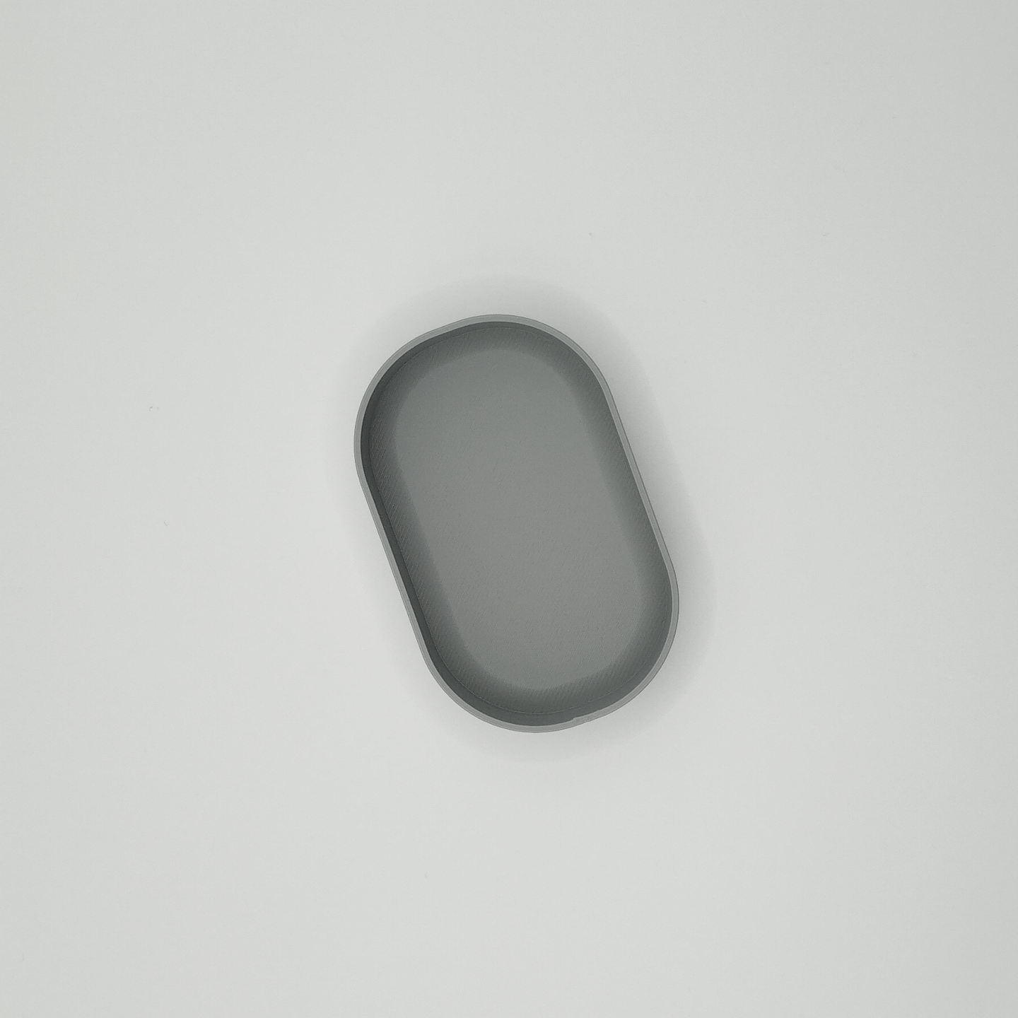 Detail of minimalist round key tray rim, showing clean edge and subtle surface finish