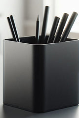 Minimalist pencil holder with clean cylindrical form, close-up view