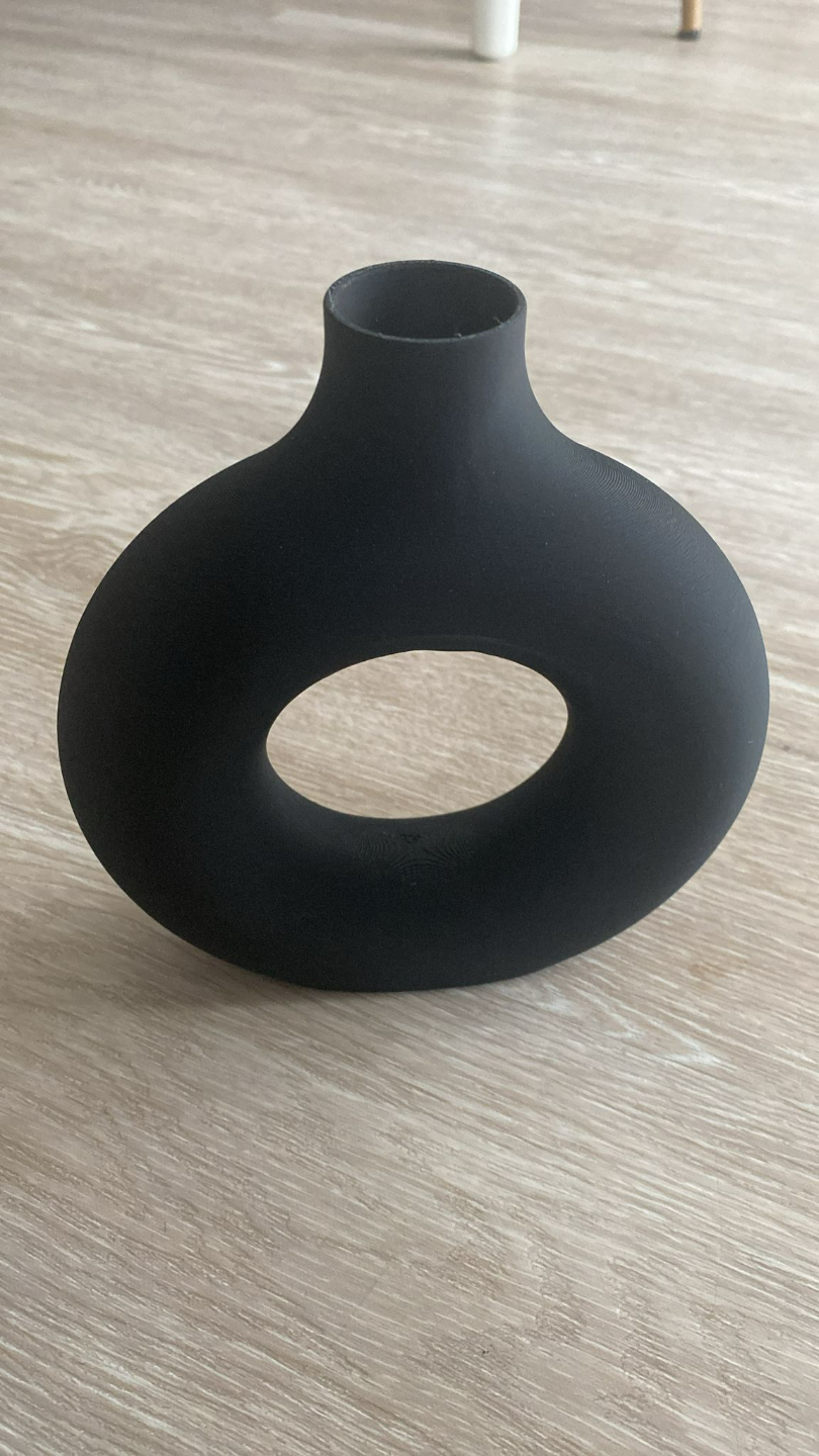 Detail of circular vase opening showing geometric hollow form and smooth surface