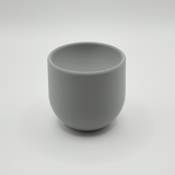 Minimal egg cup on breakfast table with soft-boiled egg and spoon