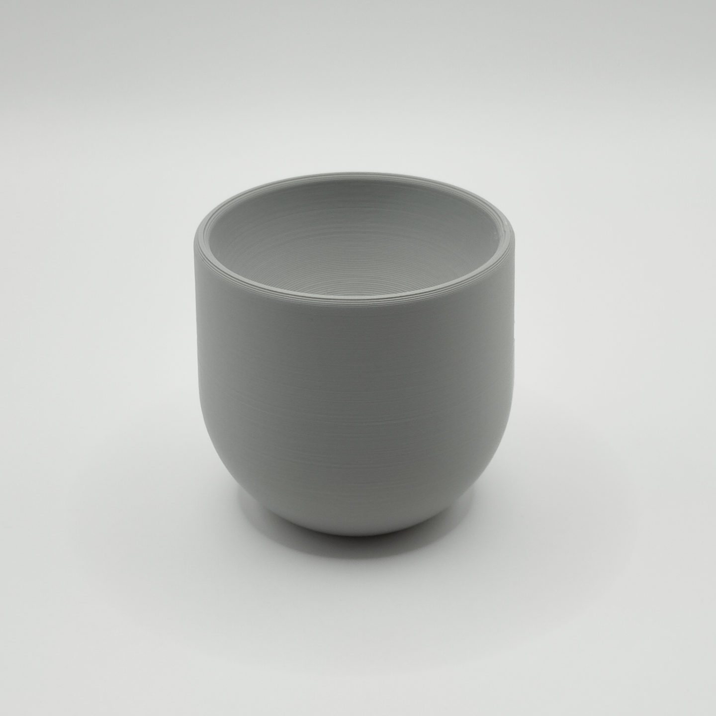 Minimal egg cup on breakfast table with soft-boiled egg and spoon