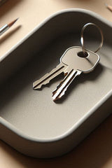 Modern key tray in soft neutral tone, close-up of smooth surface