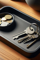 Minimalist key tray with integrated coin bowl, aerial view showing compartments