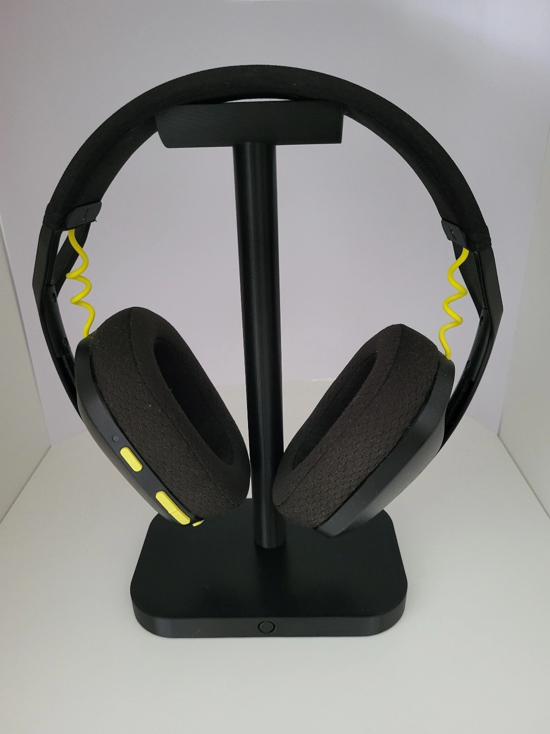 Minimalist headphone stand styled on desk next to monitor and lamp