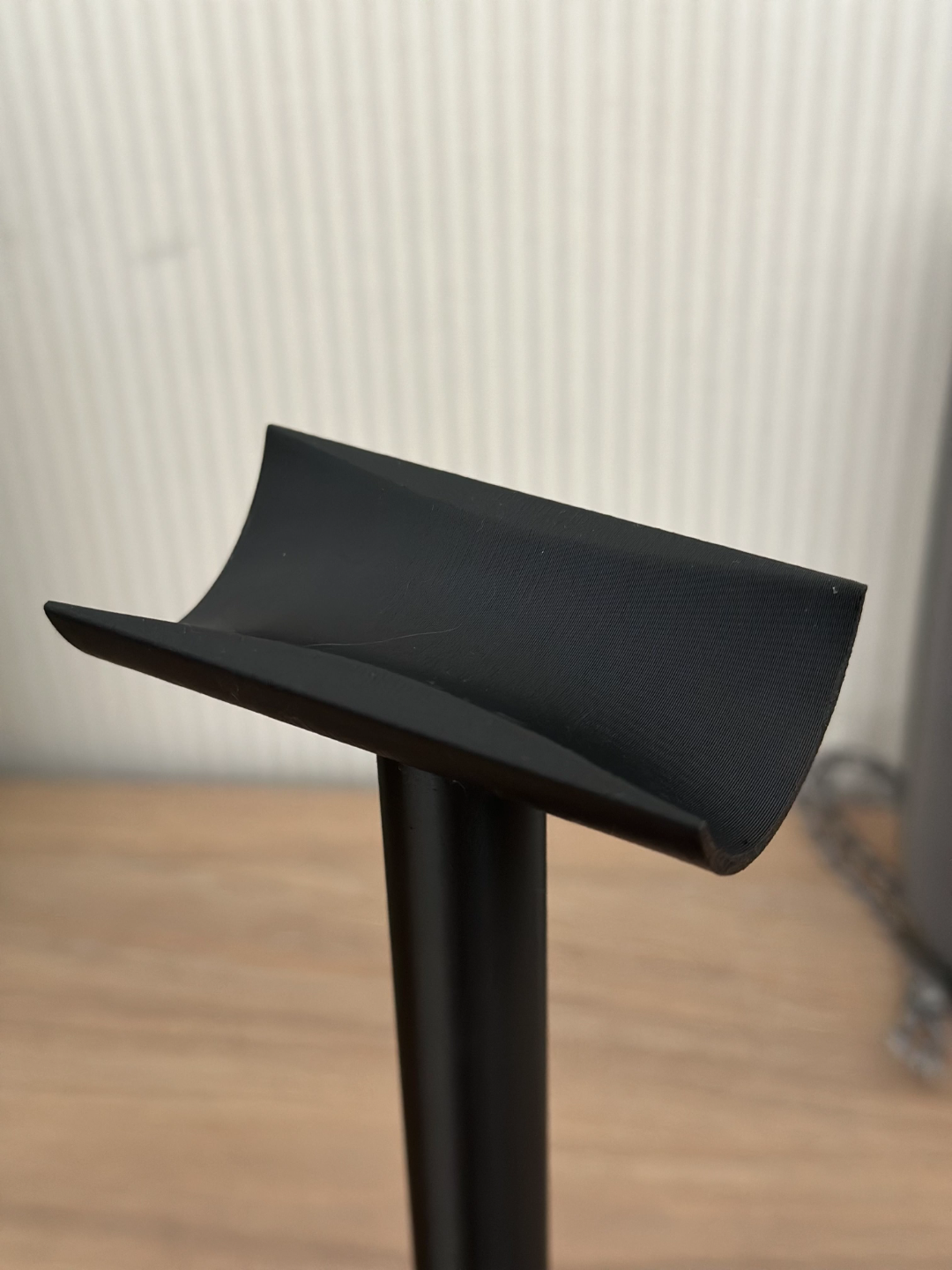 Minimalist headphone stand with clean curved arm and compact base